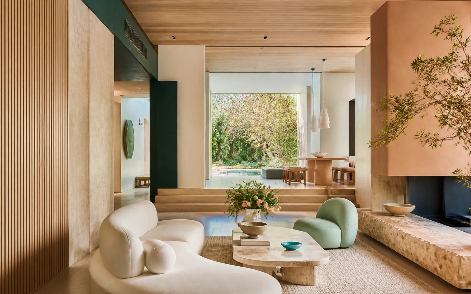 Warm contemporary living interior with natural materials, jade accents and deep-teal details